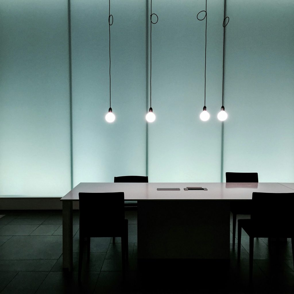 Empty meeting table with four pendant lights